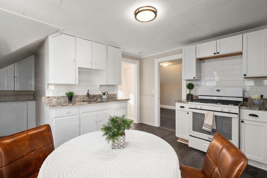 27 Dresser Street Webster, MA 01570 - Photo 22 of 33 a kitchen with stainless steel appliances a sink a stove a refrigerator dining table and chairs