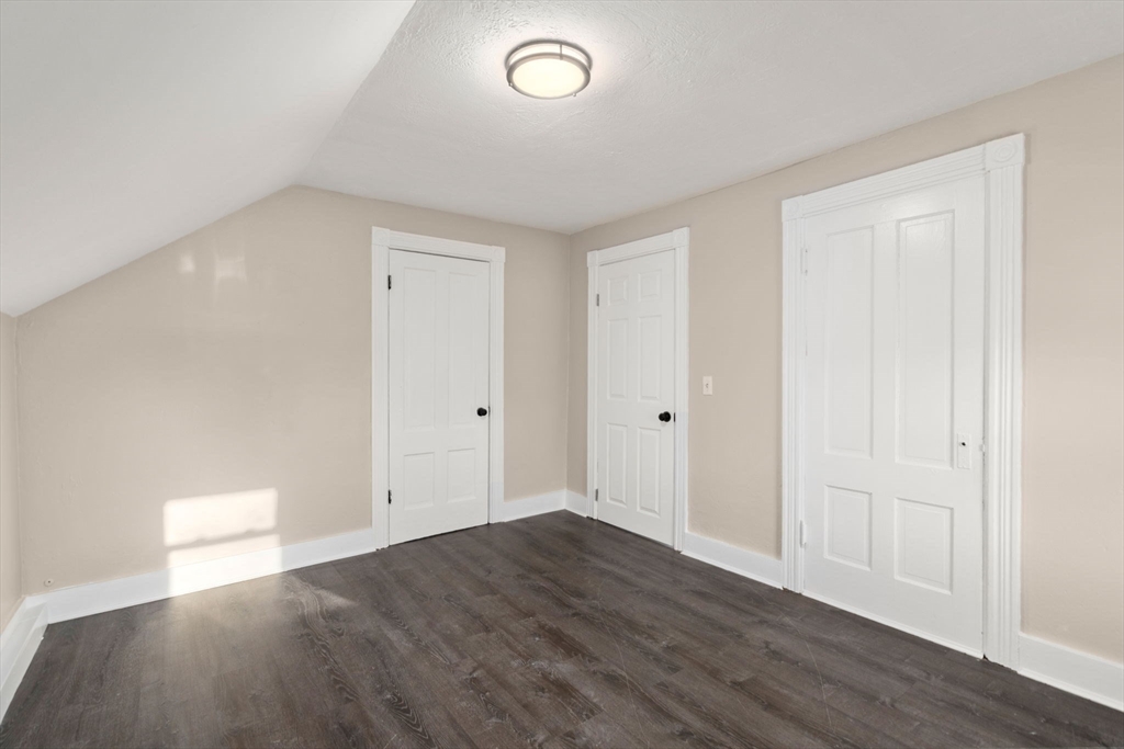 27 Dresser Street Webster, MA 01570 - Photo 27 of 33 an empty room with wooden floor and windows