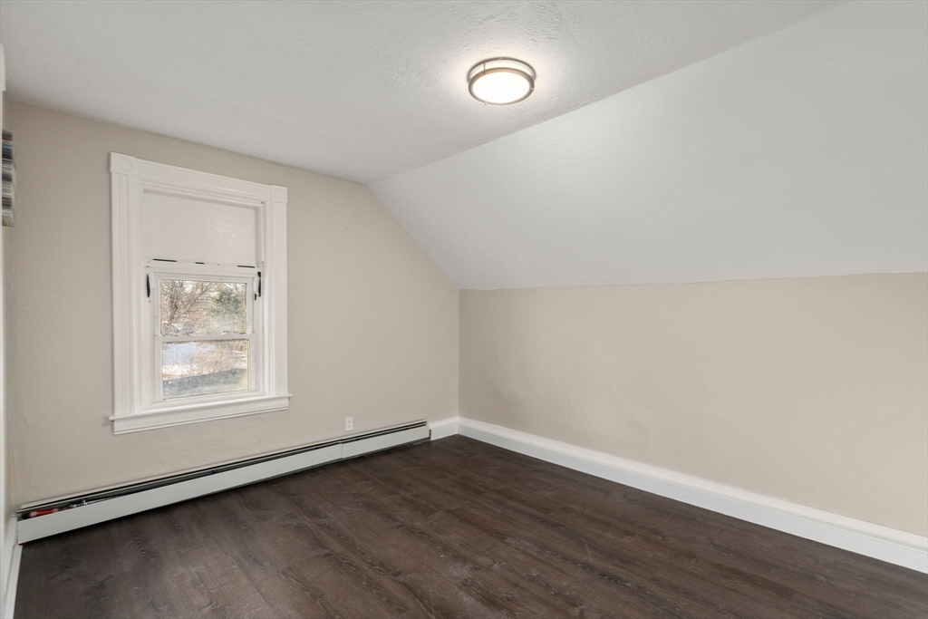 27 Dresser Street Webster, MA 01570 - Photo 28 of 33 an empty room with wooden floor and windows