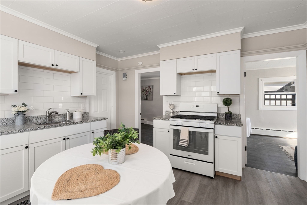 27 Dresser Street Webster, MA 01570 - Photo 7 of 33 a kitchen with stainless steel appliances a white stove top oven and white cabinets