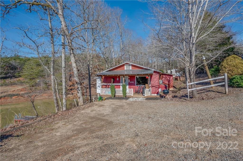 380 Happy Lane Rutherfordton, NC 28139 - Photo 16 of 45 a view of patio with a table and chairs under an umbrella