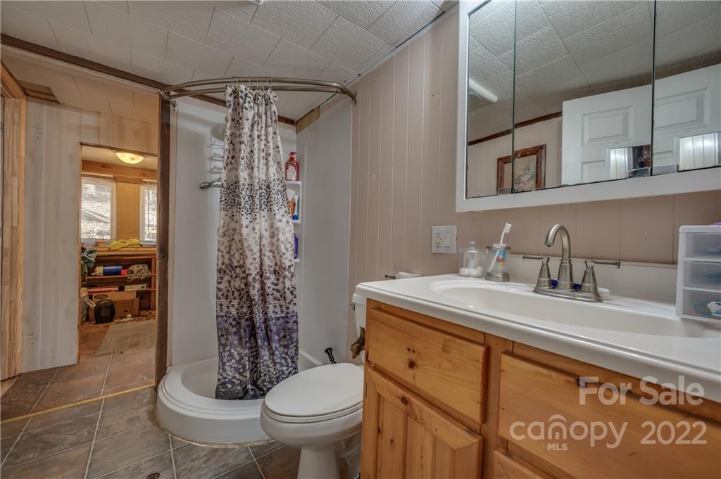 380 Happy Lane Rutherfordton, NC 28139 - Photo 10 of 45 a bathroom with a granite countertop sink toilet and shower