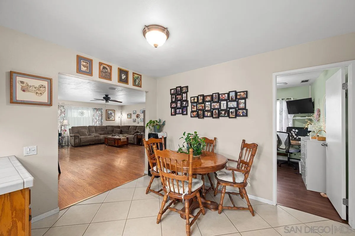 9948 Kincaid Street Santee, CA 92071 - Photo 14 of 53 a dining room with furniture and a wooden floor