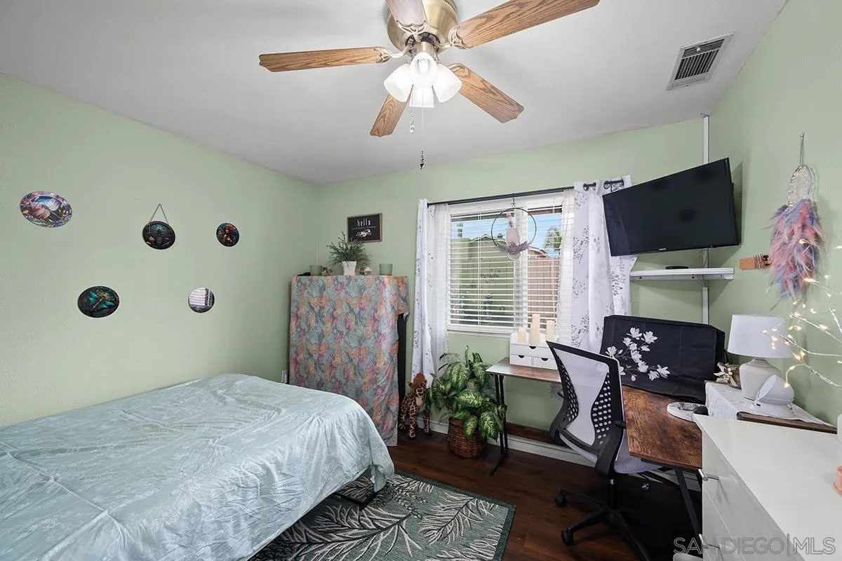 9948 Kincaid Street Santee, CA 92071 - Photo 19 of 53 a bedroom with furniture and a flat screen tv