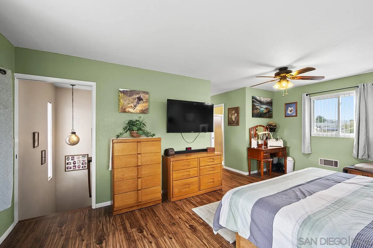 9948 Kincaid Street Santee, CA 92071 - Photo 23 of 53 a bedroom with a bed and wooden floor