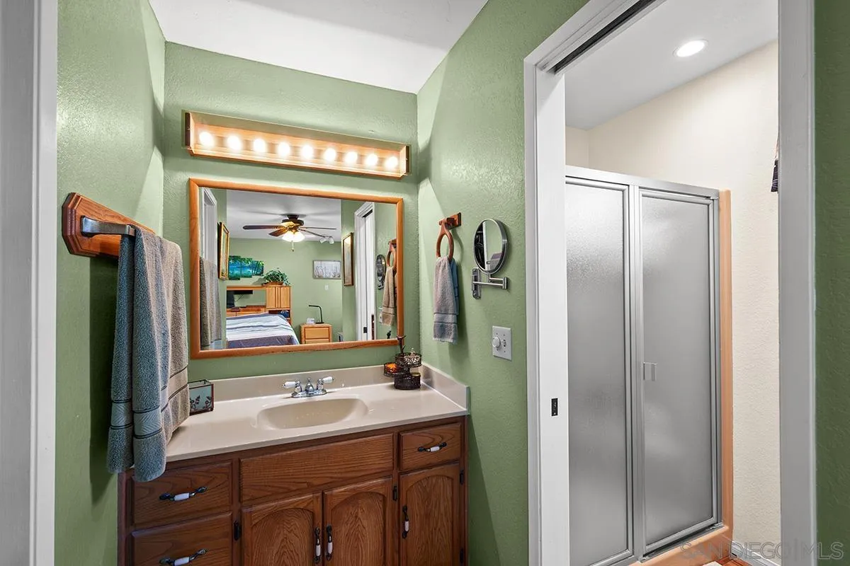 9948 Kincaid Street Santee, CA 92071 - Photo 28 of 53 a bathroom with a sink a mirror and a window