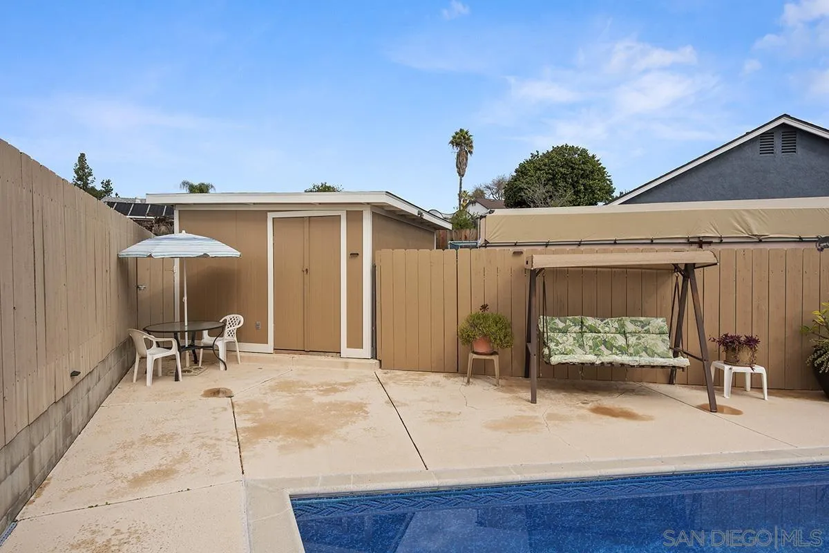 9948 Kincaid Street Santee, CA 92071 - Photo 40 of 53 a view of a patio with table and chairs under an umbrella