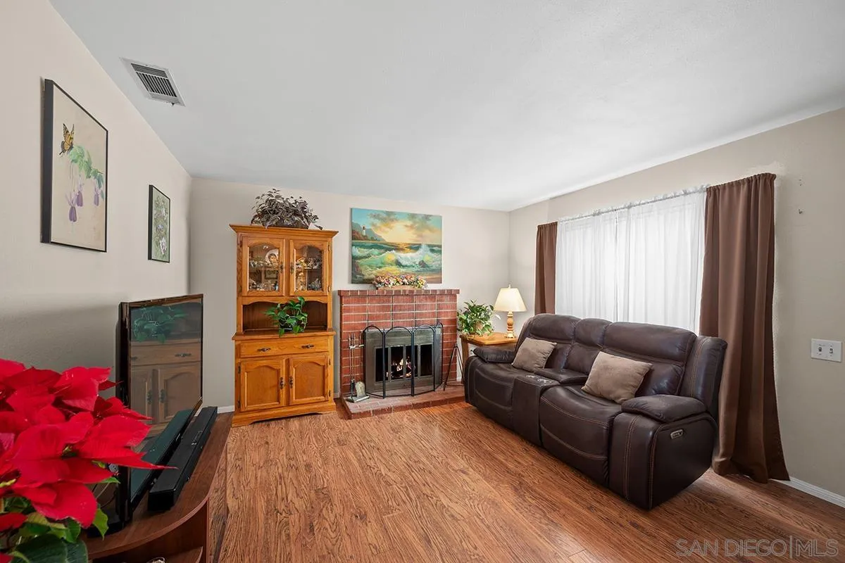 9948 Kincaid Street Santee, CA 92071 - Photo 7 of 53 a living room with furniture a fireplace and a flat screen tv