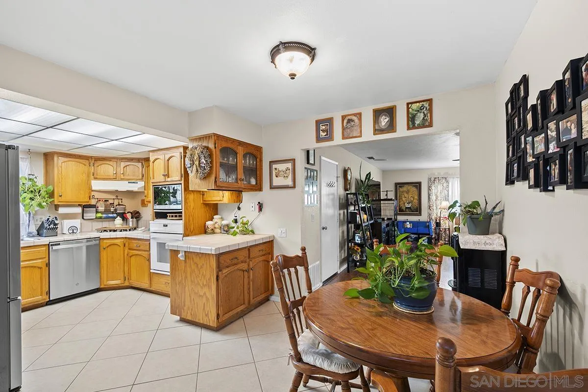 9948 Kincaid Street Santee, CA 92071 - Photo 10 of 53 a view of a dining room with furniture window and wooden floor