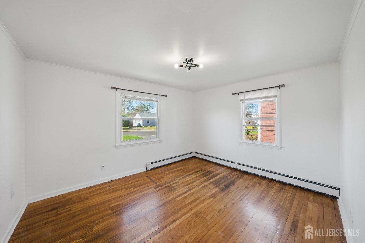 94 South Hill Road Colonia, NJ 07067 - Photo 11 of 31 a view of an empty room with wooden floor and a window