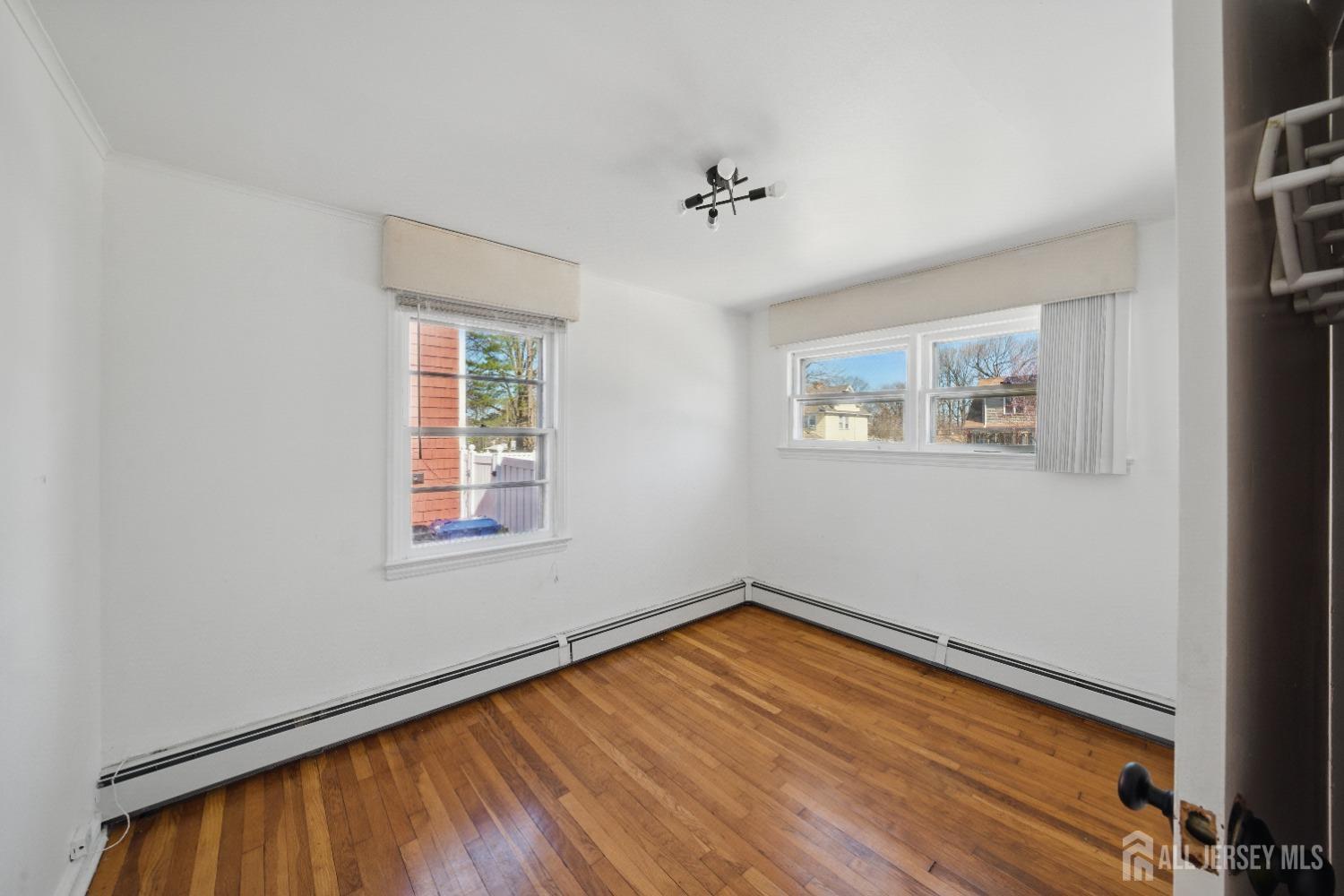 94 South Hill Road Colonia, NJ 07067 - Photo 15 of 31 a view of empty room with wooden floor and fan