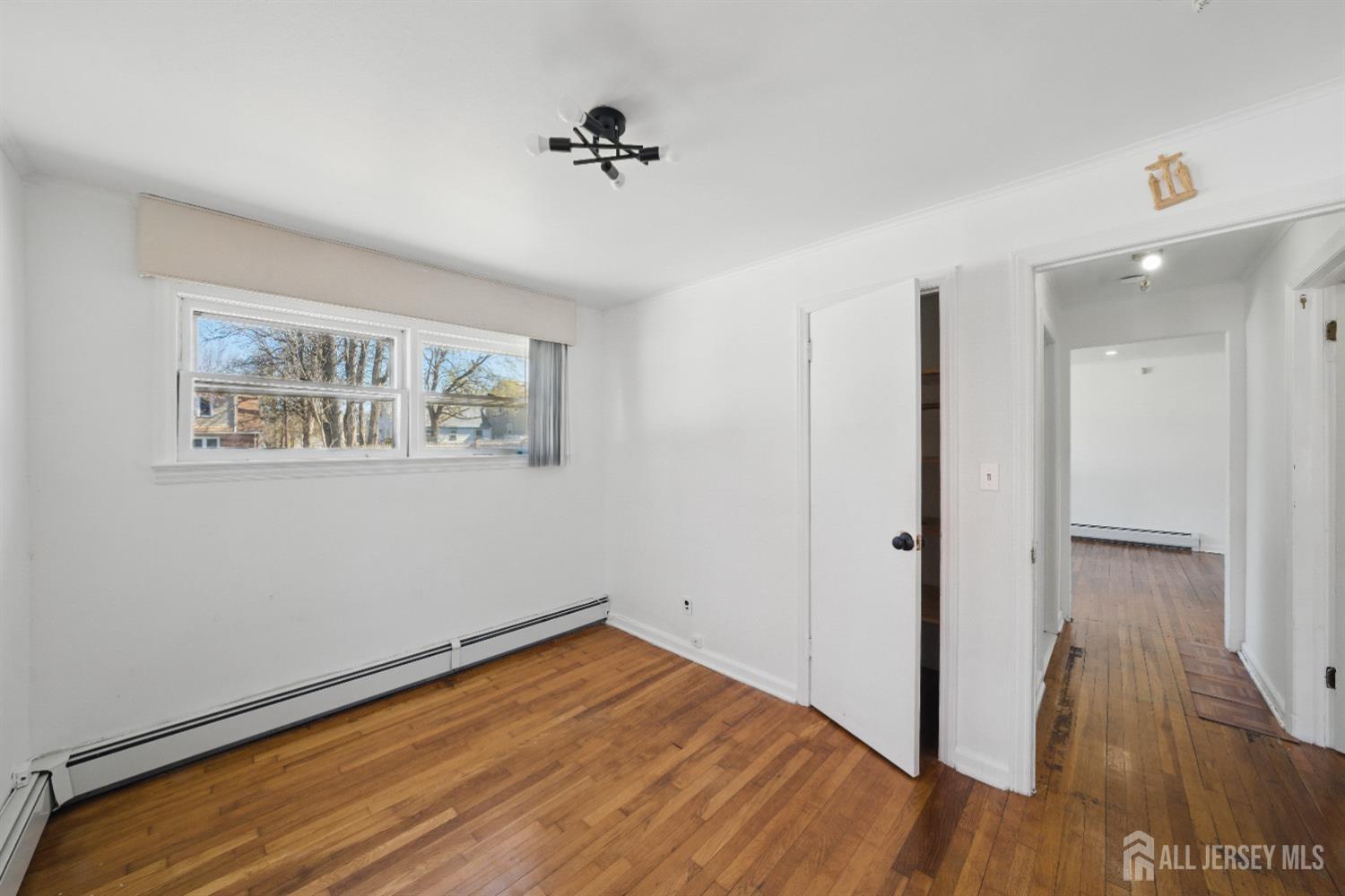 94 South Hill Road Colonia, NJ 07067 - Photo 16 of 31 a view of a room with wooden floor and closet