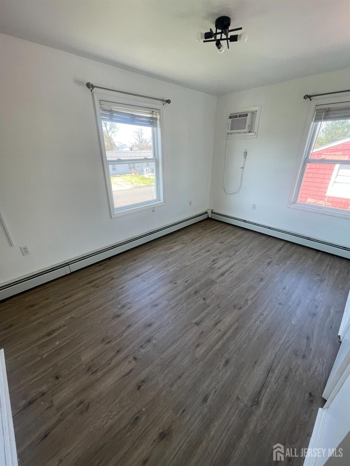 94 South Hill Road Colonia, NJ 07067 - Photo 19 of 31 wooden floor in an empty room with a window