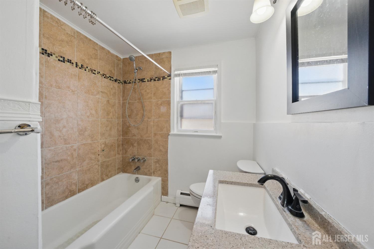 94 South Hill Road Colonia, NJ 07067 - Photo 20 of 31 a bathroom with a tub a sink and a toilet