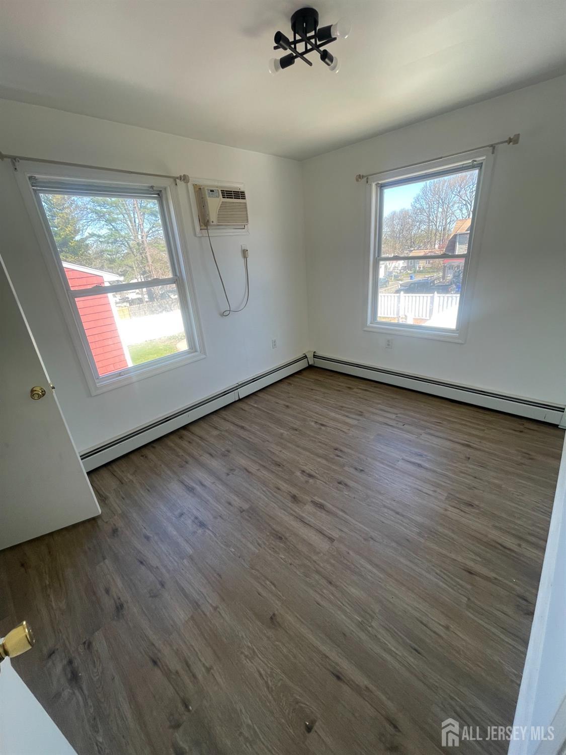 94 South Hill Road Colonia, NJ 07067 - Photo 21 of 31 a view of an empty room with wooden floor and a window