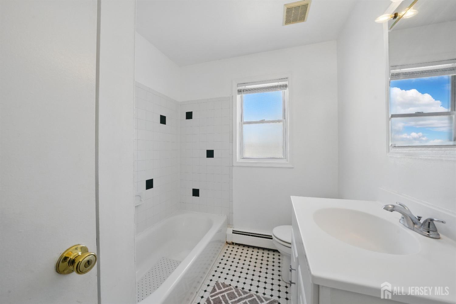 94 South Hill Road Colonia, NJ 07067 - Photo 22 of 31 a bathroom with a sink a toilet and shower