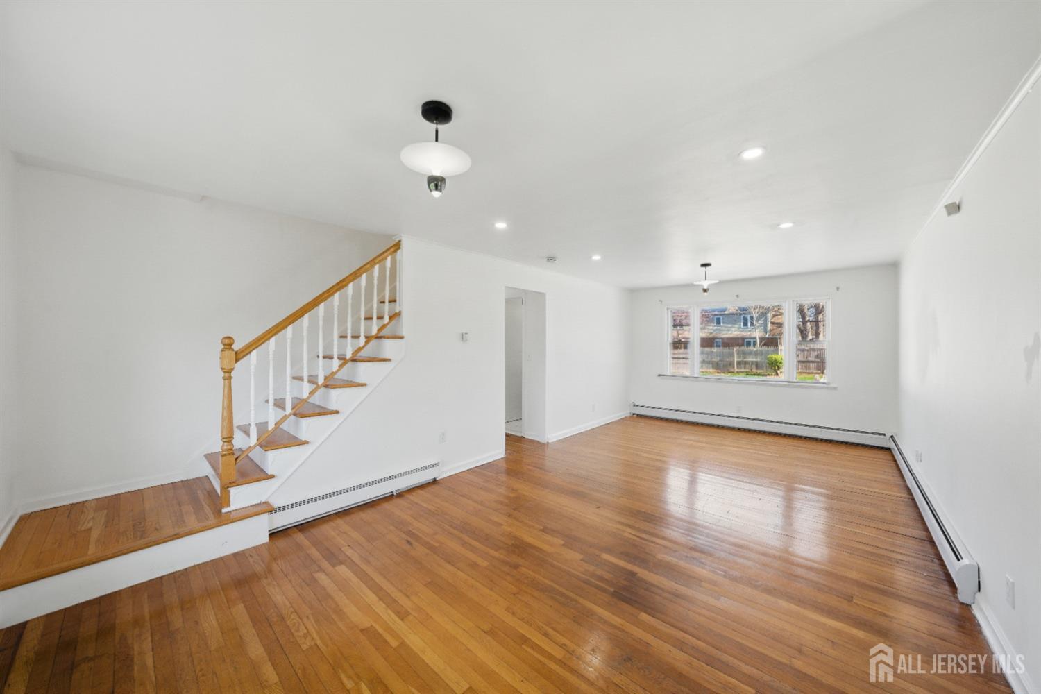 94 South Hill Road Colonia, NJ 07067 - Photo 4 of 31 a view of an empty room with wooden floor and a window