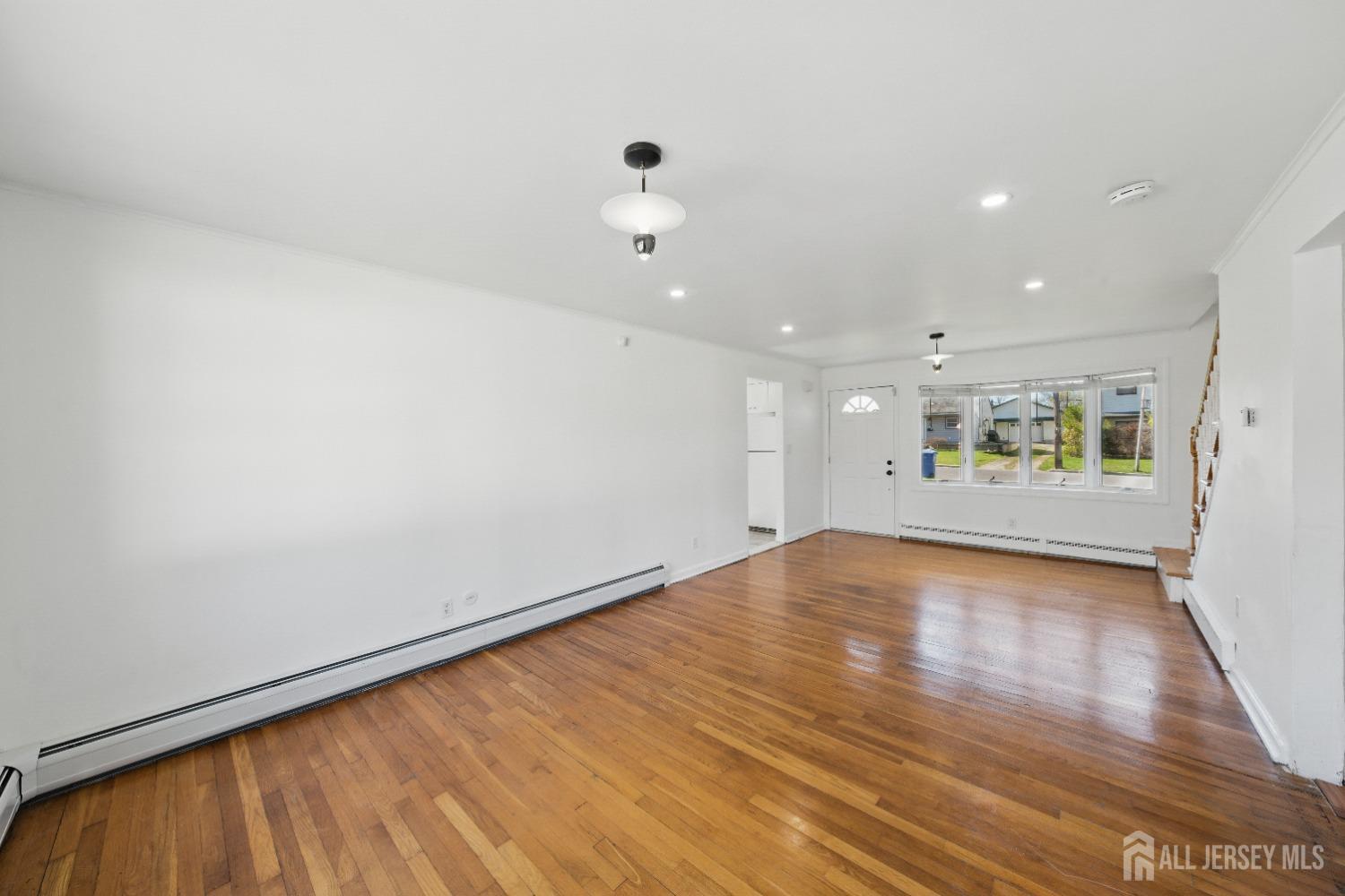 94 South Hill Road Colonia, NJ 07067 - Photo 5 of 31 a view of an empty room with wooden floor and a window