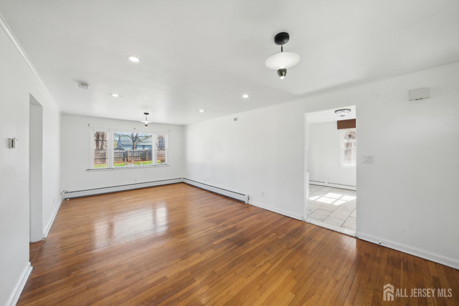 94 South Hill Road Colonia, NJ 07067 - Photo 6 of 31 a view of an empty room with wooden floor and a window