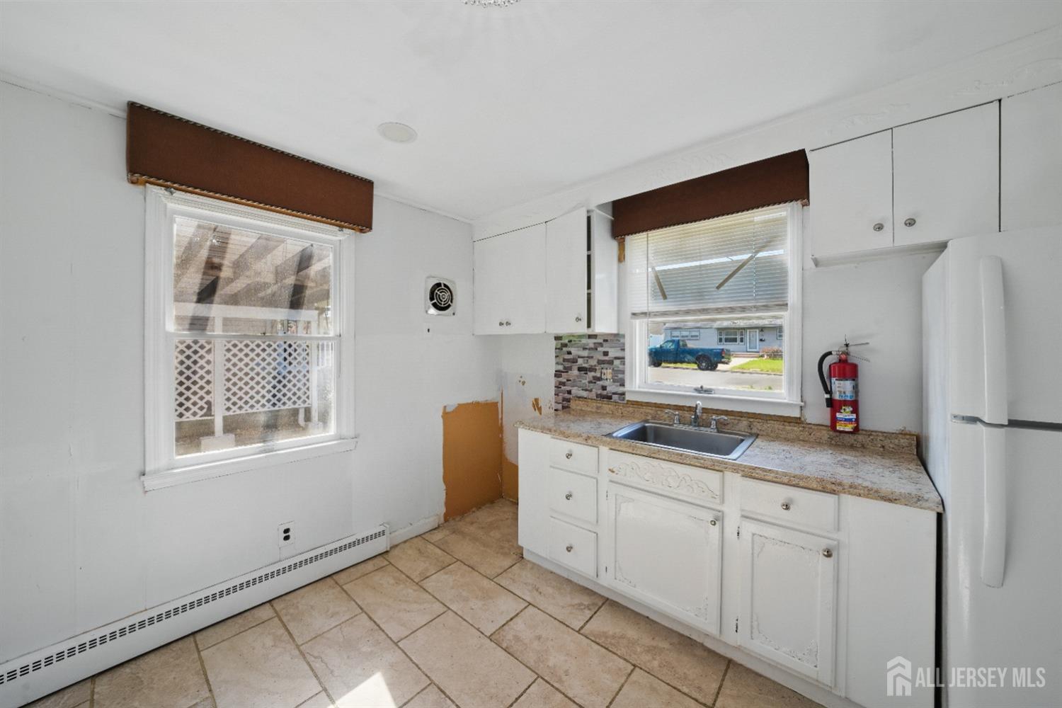 94 South Hill Road Colonia, NJ 07067 - Photo 9 of 31 a kitchen with a sink cabinets and window