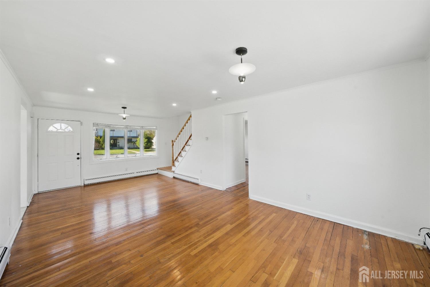 94 South Hill Road Colonia, NJ 07067 - Photo 10 of 31 a view of an empty room with wooden floor and a window
