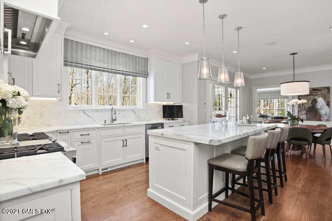 7 Desiree Drive Greenwich, CT 06830 - Photo 12 of 39 a kitchen with center island white cabinets and white appliances