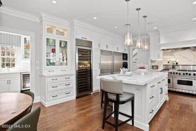 7 Desiree Drive Greenwich, CT 06830 - Photo 13 of 39 a kitchen with a table chairs stainless steel appliances and cabinets