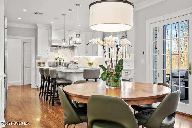 7 Desiree Drive Greenwich, CT 06830 - Photo 15 of 39 a dining room with furniture a rug a potted plant and a chandelier