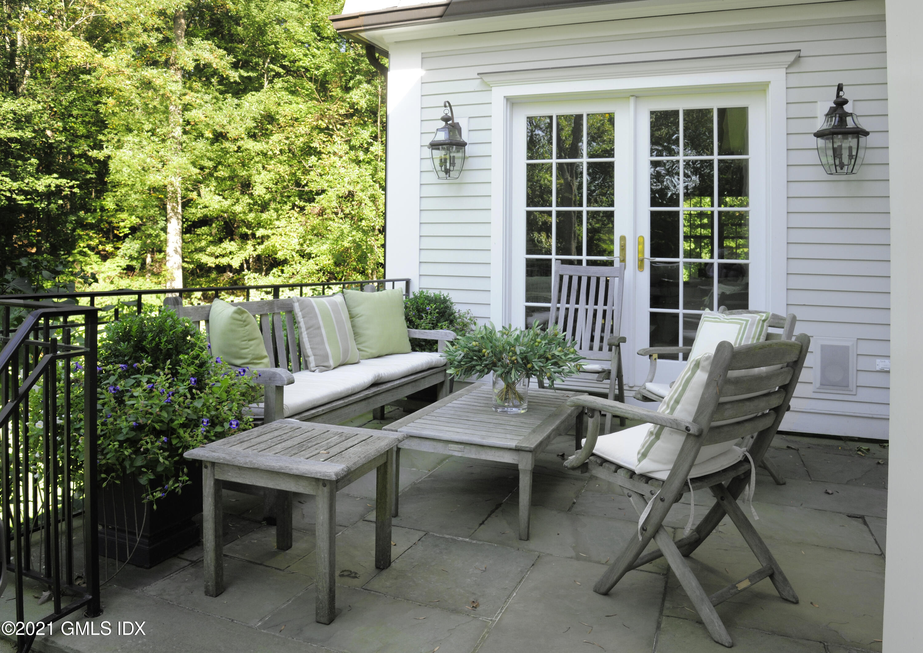 7 Desiree Drive Greenwich, CT 06830 - Photo 16 of 39 a view of a patio with table and chairs and potted plants