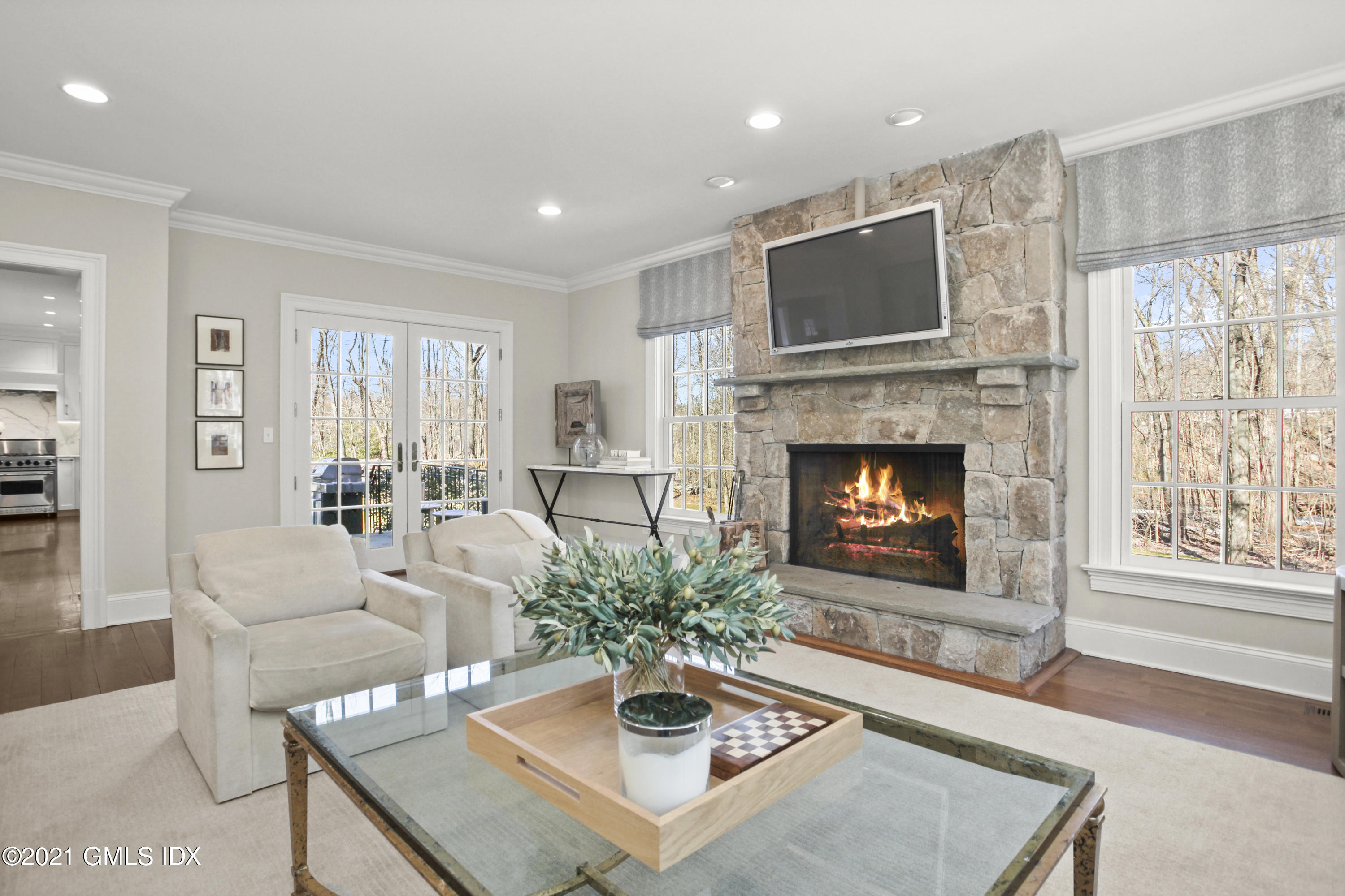 7 Desiree Drive Greenwich, CT 06830 - Photo 18 of 39 a living room with furniture a fireplace and a flat screen tv