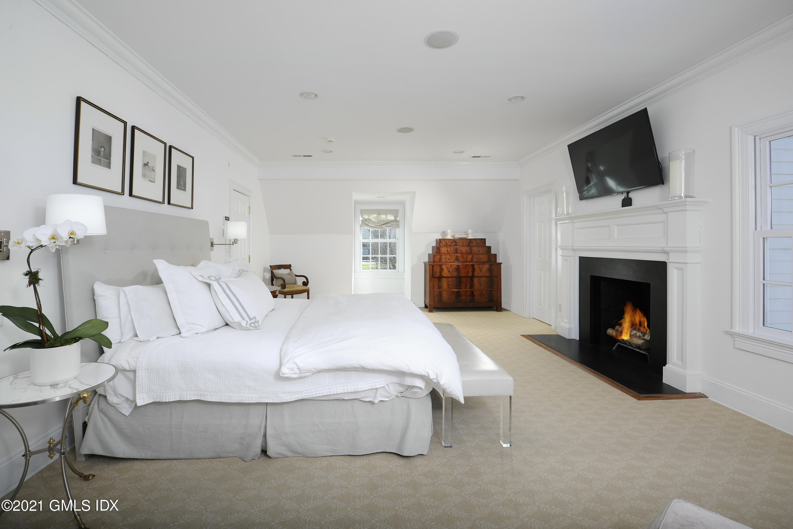 7 Desiree Drive Greenwich, CT 06830 - Photo 19 of 39 a spacious bedroom with a bed and a fireplace