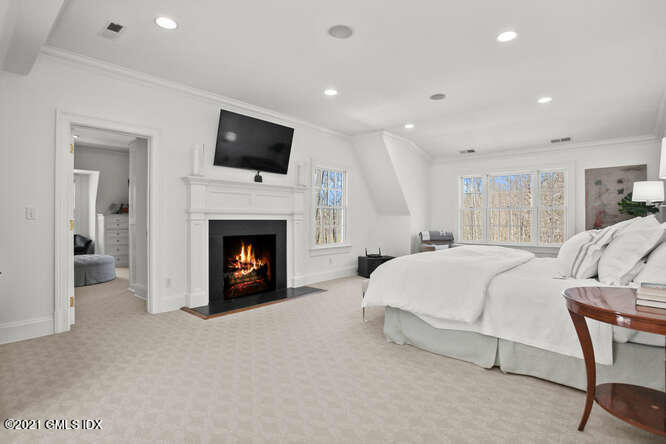 7 Desiree Drive Greenwich, CT 06830 - Photo 20 of 39 a bed room with a bed and a fireplace