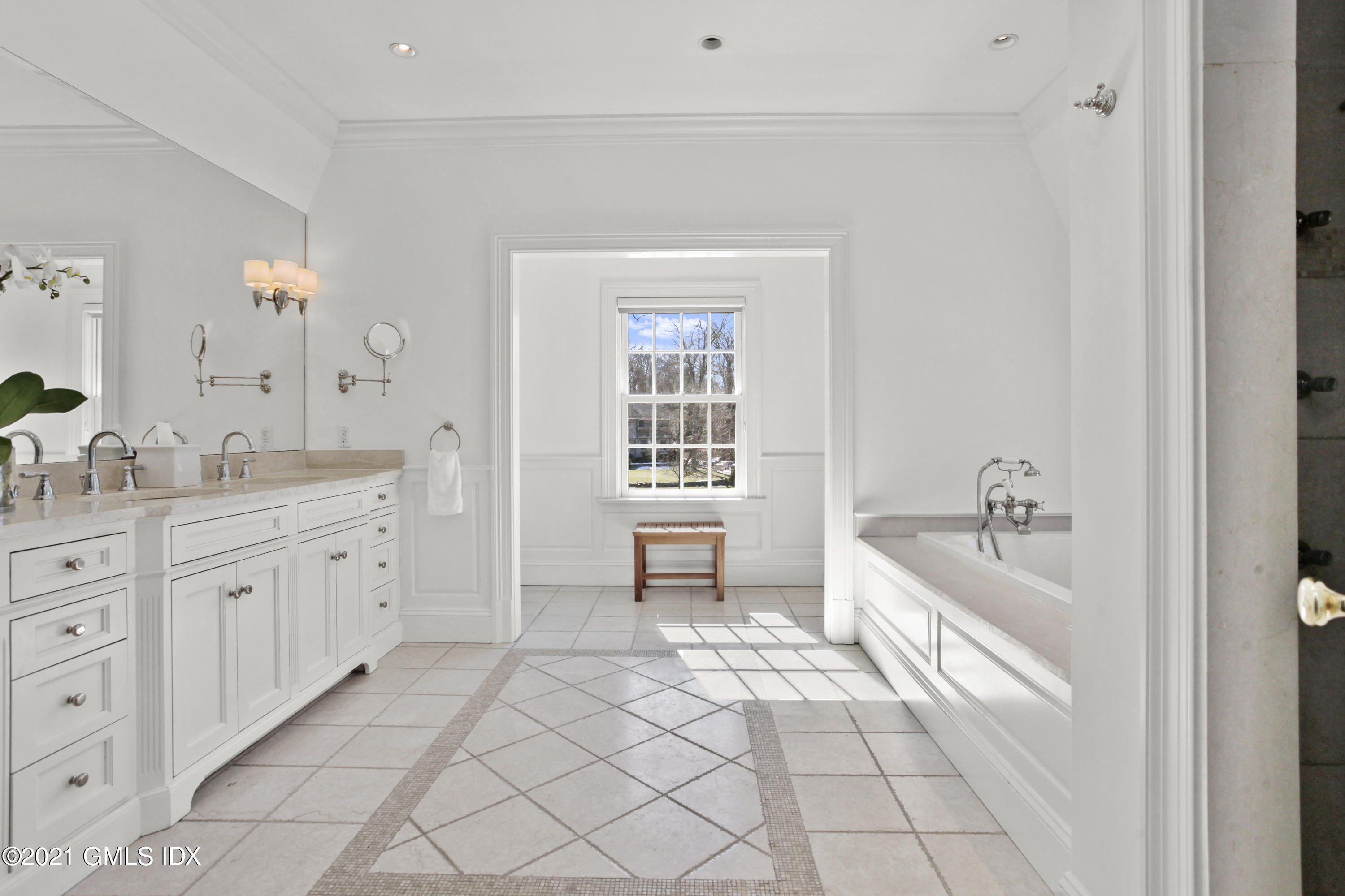 7 Desiree Drive Greenwich, CT 06830 - Photo 22 of 39 a spacious bathroom with a double vanity sink a mirror and a bathtub