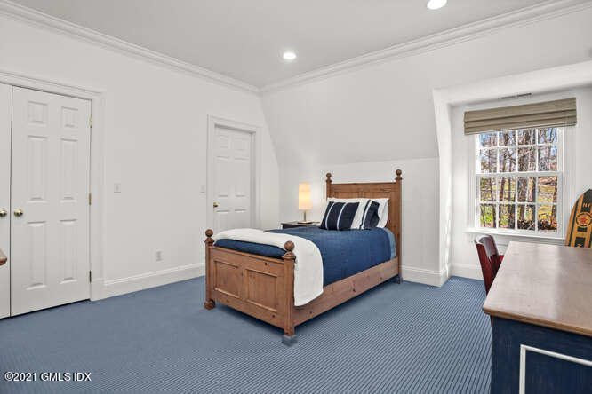 7 Desiree Drive Greenwich, CT 06830 - Photo 27 of 39 a bedroom with a bed and window