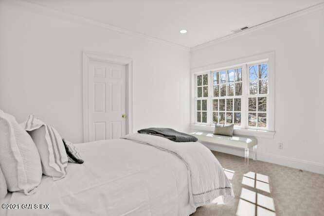 7 Desiree Drive Greenwich, CT 06830 - Photo 31 of 39 a bedroom with a bed and a large window