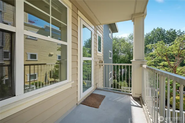 a view of a balcony with floor to ceiling windows and wooden floor