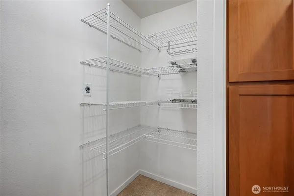a view of walk in closet with empty racks