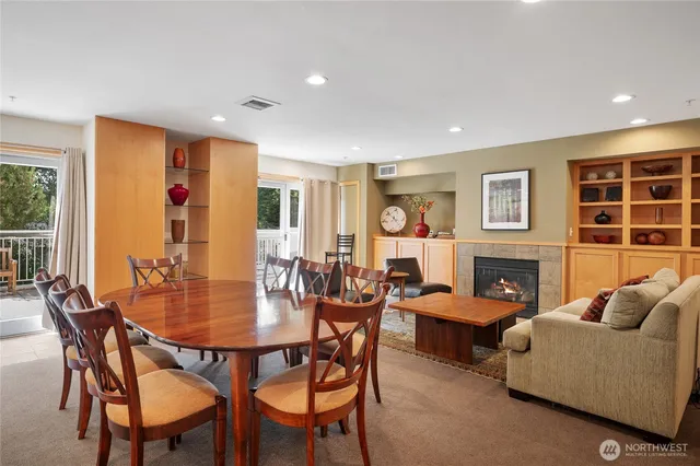 a living room with furniture a fireplace and a large window