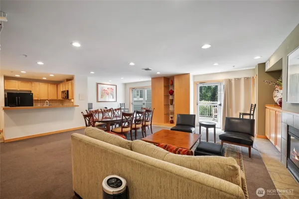 a living room with furniture and a view of kitchen livingroom