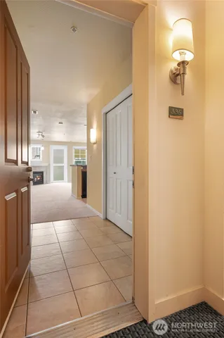 a view of a hallway with wooden floor and a bathroom