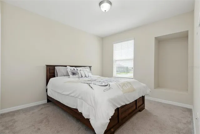 a bedroom with a bed and a couch