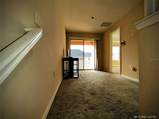 a balcony with wooden floor and city view