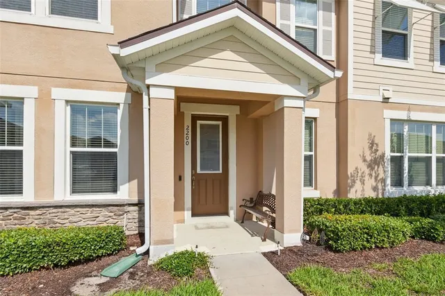a living room with furniture a flat screen tv and a window