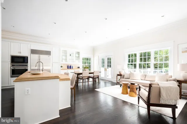 a living room with furniture a flat screen tv and a large window