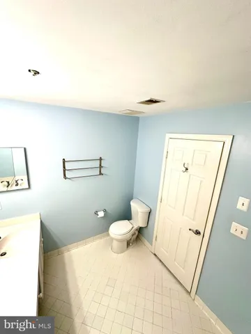 a bathroom with a bathtub sink mirror and toilet