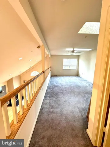 a view of a balcony with floor to ceiling windows and wooden fence