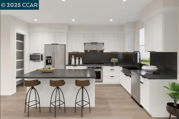 a kitchen with stainless steel appliances kitchen island granite countertop a table chairs and a refrigerator