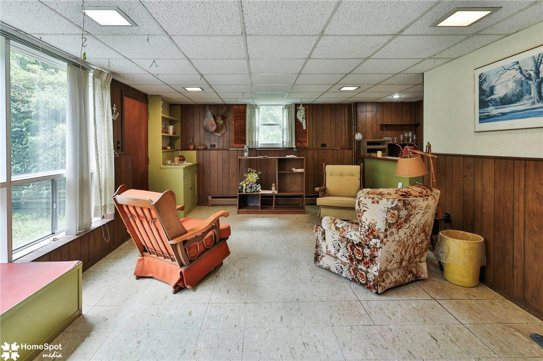 6054 Old Hickory Road Coopersburg, PA 18036 - Photo 30 of 48 Rich wood paneling and large windows define this versatile lower level recreation area.