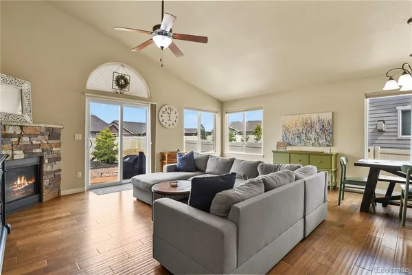 a living room with fireplace furniture and a wooden floor