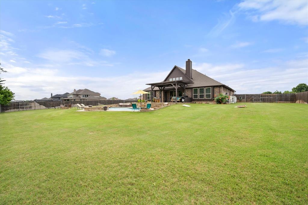445 Rusty Run Drive Midlothian, TX 76065 - Photo 37 of 40 a view of a house with a garden and lake view